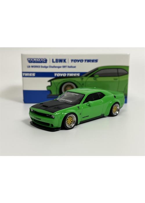 a green toy car next to a box