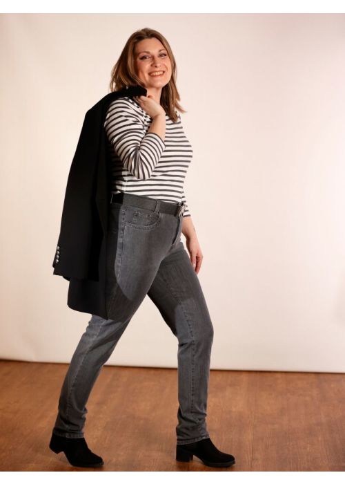 a woman in a striped shirt and jeans