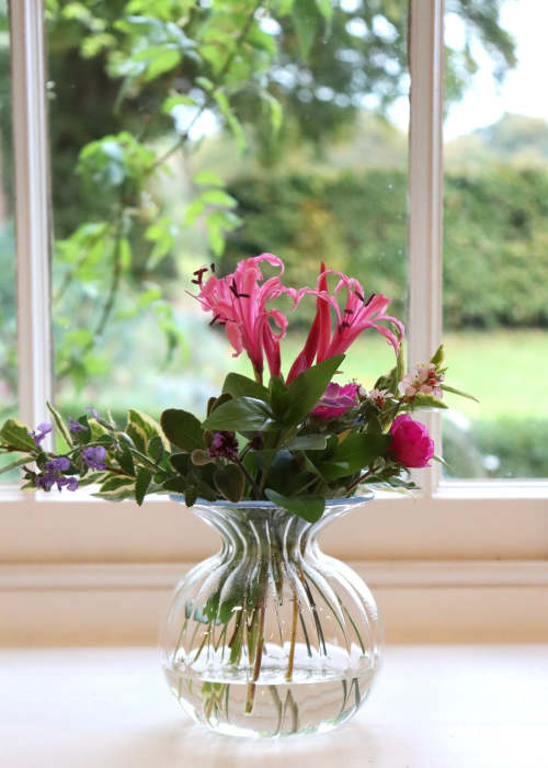 a glass vase with flowers in it