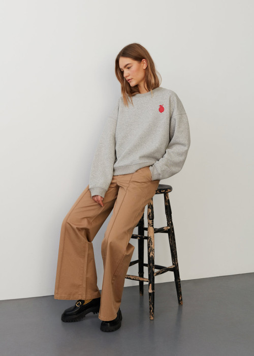 a woman sitting on a stool