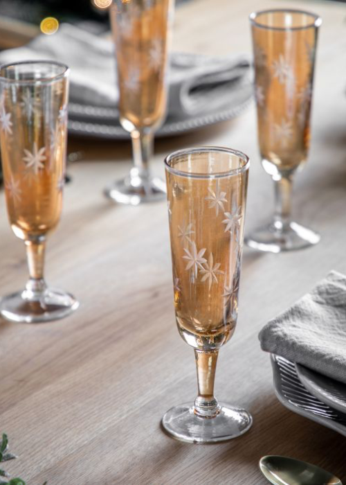 a group of champagne glasses on a table
