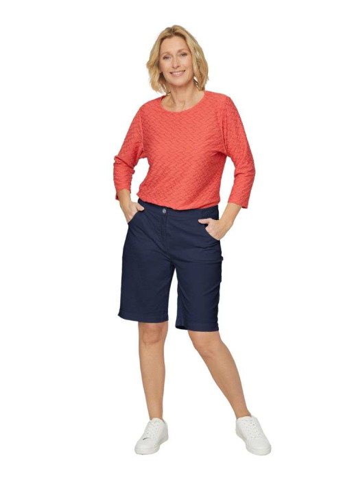 a woman in shorts and a red shirt
