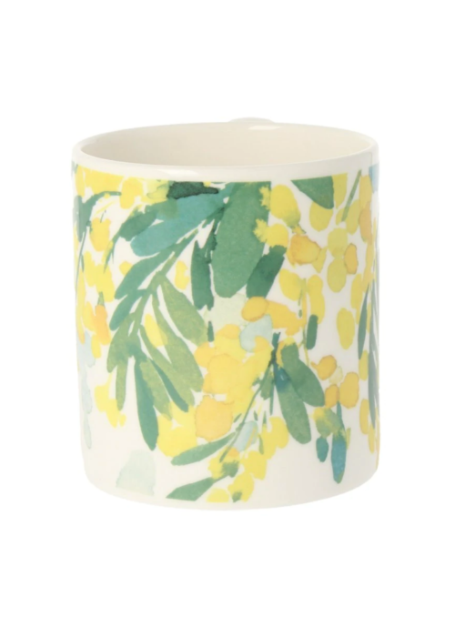 a white and yellow mug with green leaves on it
