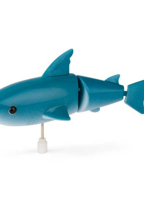 a blue toy shark on a white background