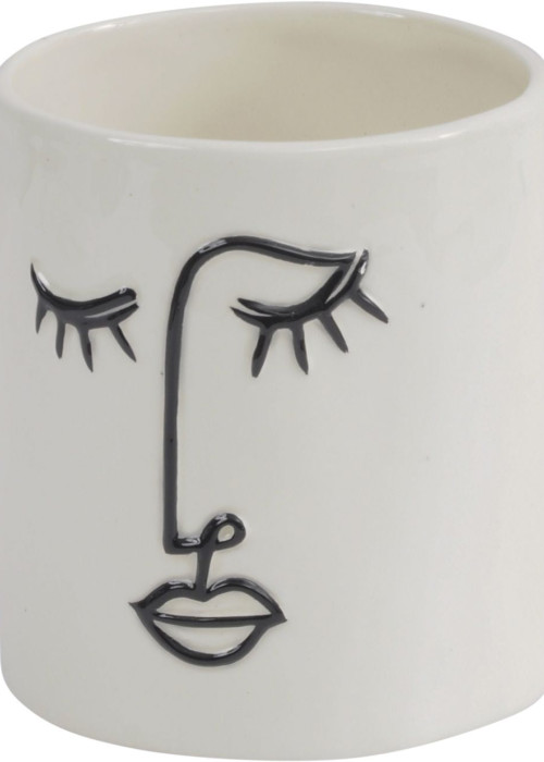 a white cup with a face drawn on it