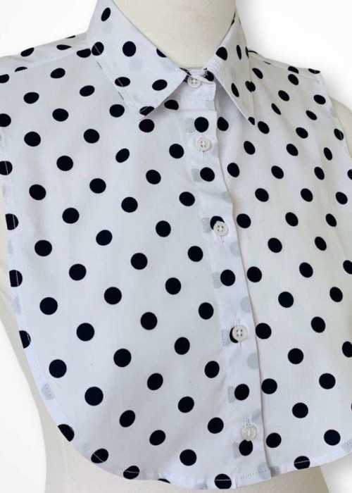 a white shirt with black dots on it