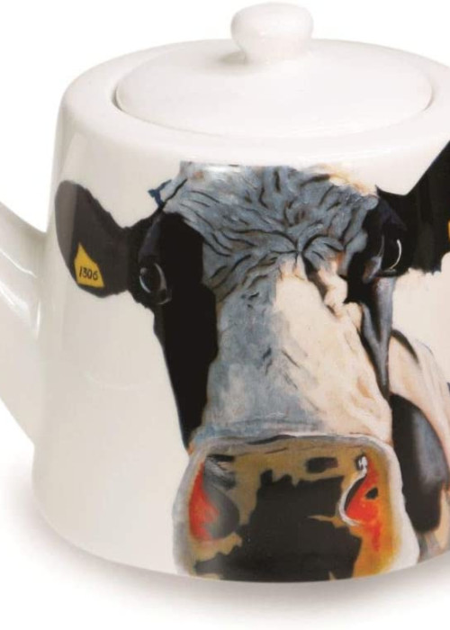 a teapot with a cow painting on it