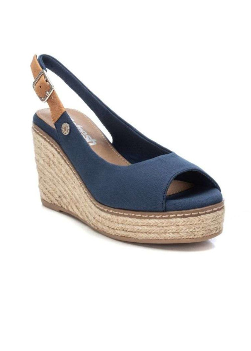 a blue wedge sandal with a brown strap