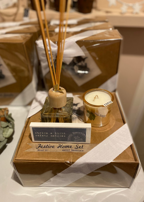 a box with a candle and a reed diffuser