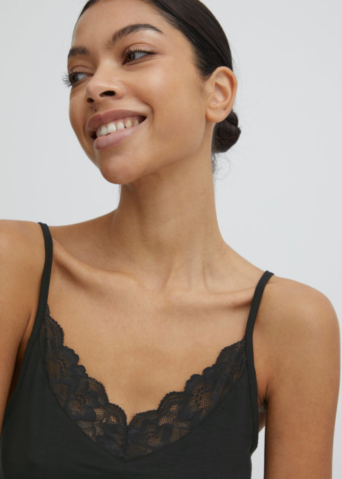 a woman smiling with a black top