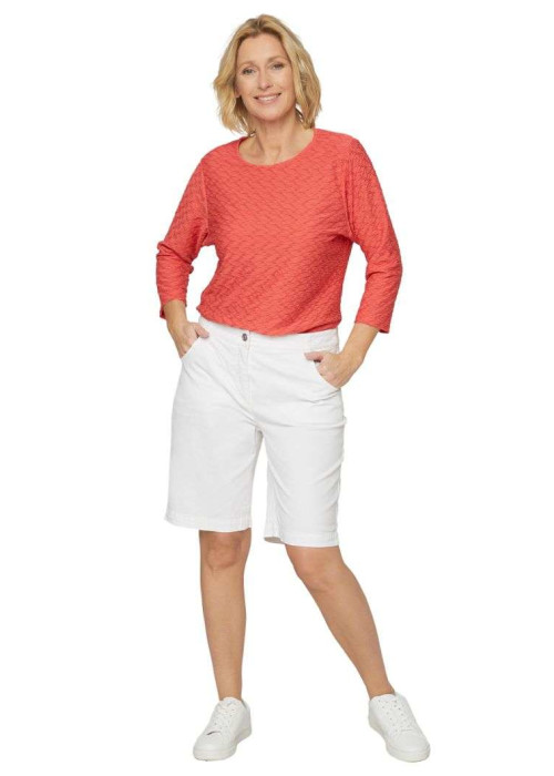 a woman in white shorts and red shirt