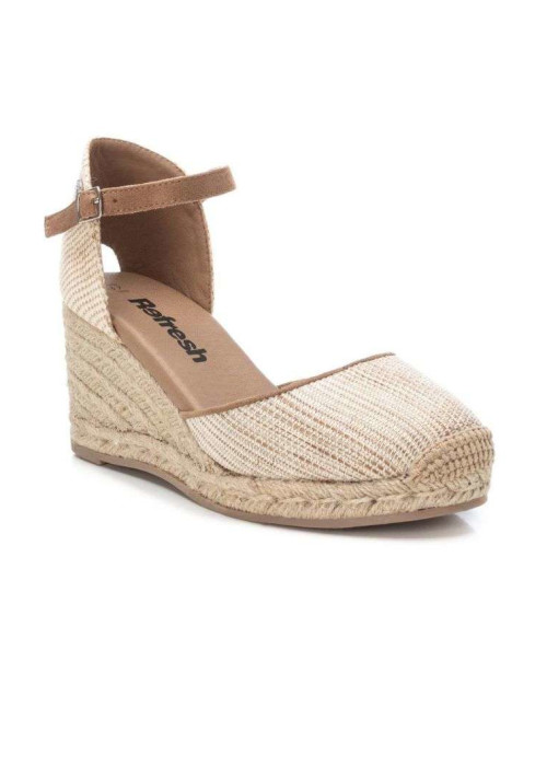 a tan and tan wedge shoe