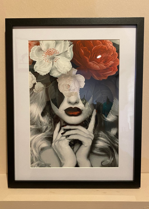 a framed picture of a woman with flowers