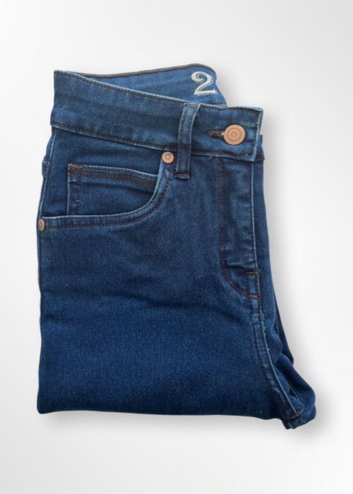 a folded blue jeans on a white background