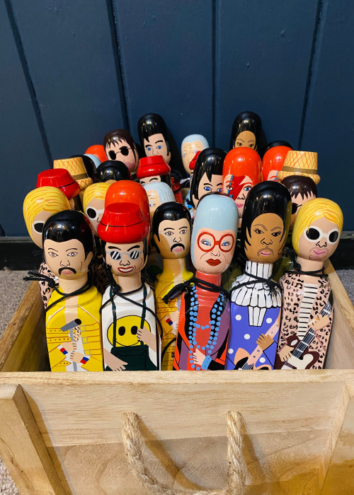 a group of Wedgie Doorstops in a wooden box