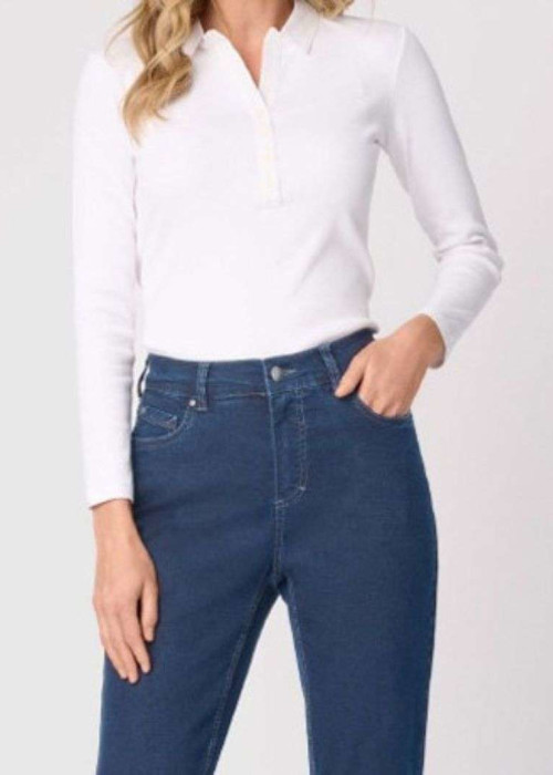 a woman wearing a white shirt and blue jeans