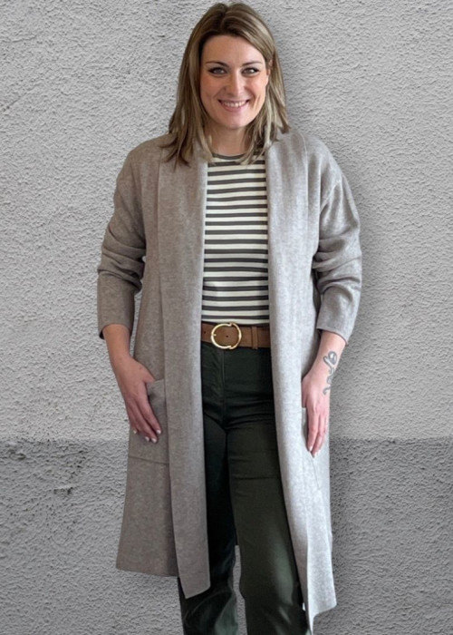 a woman standing in front of a wall