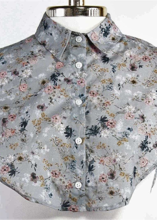 a grey floral shirt with white buttons