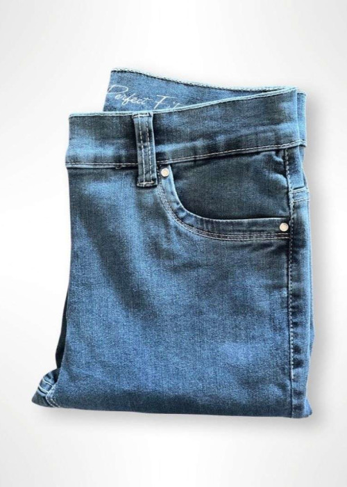 a folded blue jeans on a white background