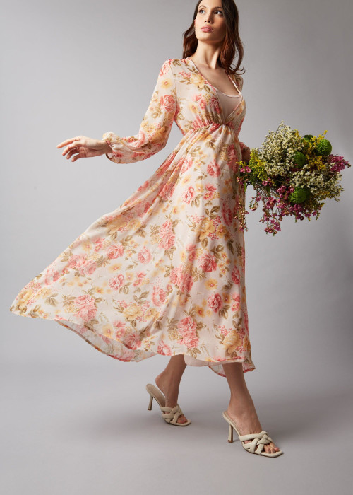 a woman in a dress holding flowers