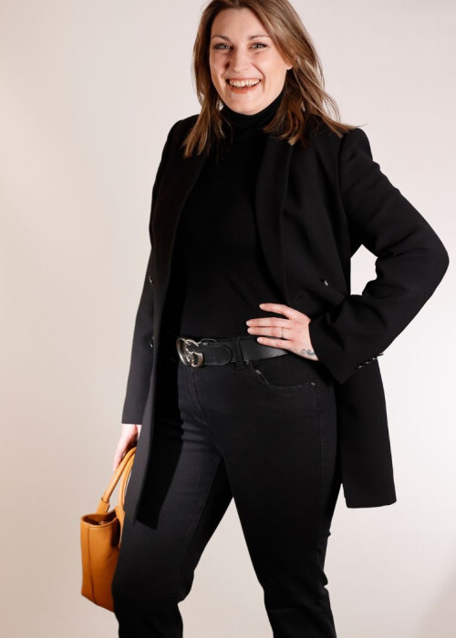 a woman in black suit and black pants