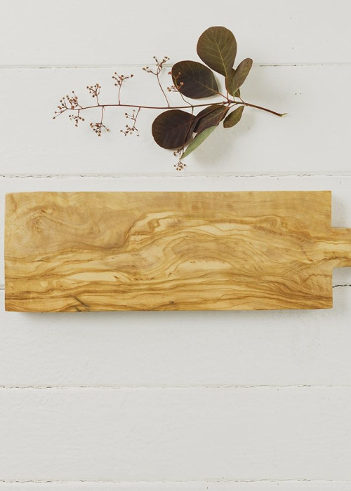 a wooden cutting board and a plant