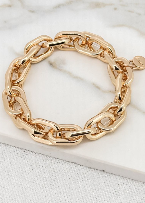 a gold chain bracelet on a marble surface