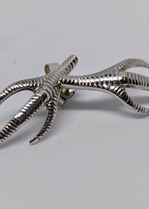 a silver claw shaped object