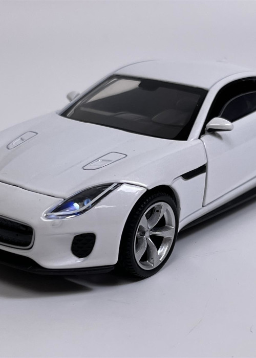 a white toy car on a white background