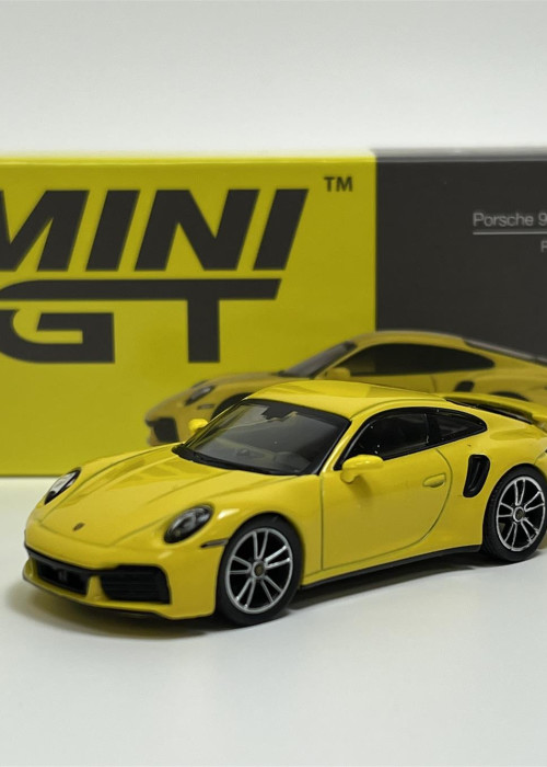 a yellow toy car next to a box