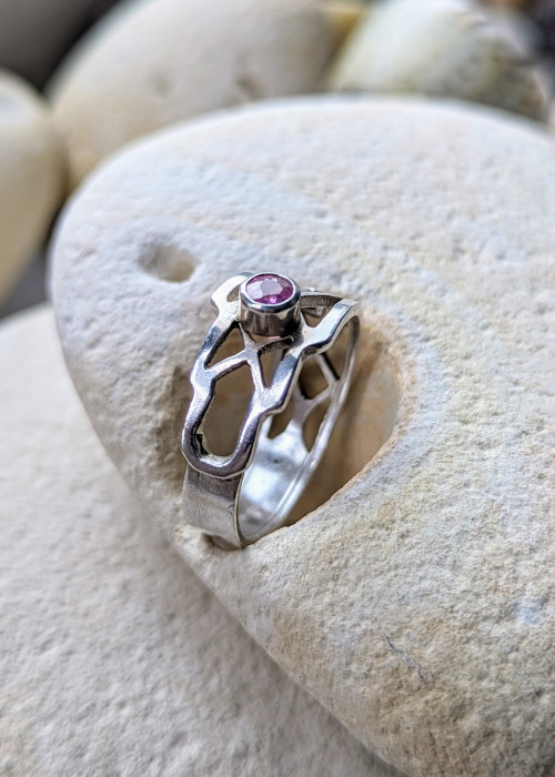 a ring with a pink stone in it