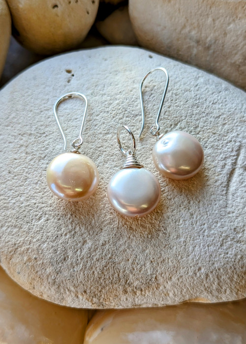 a group of pearl earrings on a rock