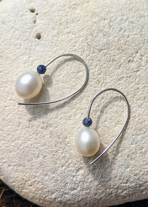 a pair of earrings on a rock