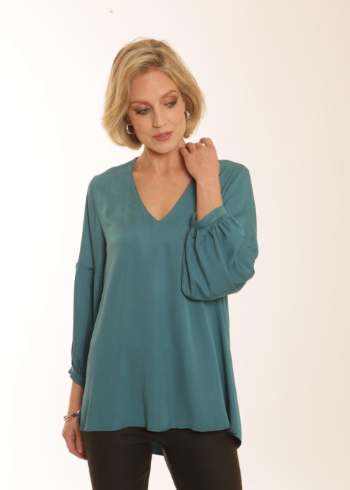 a woman in a teal blouse