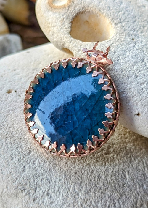 a blue stone with a gold border on top of it