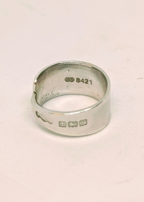 a silver ring with engraved text