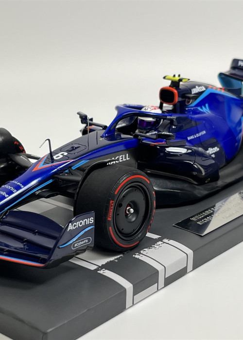 a blue race car on a grey surface
