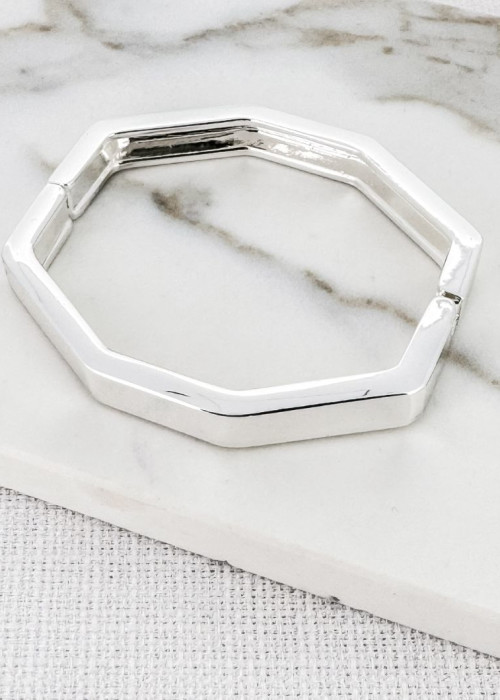 a silver bracelet on a marble surface