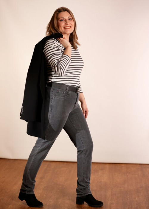 a woman in a striped shirt and jeans