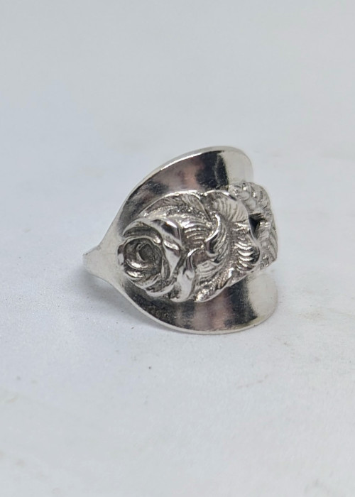 a silver ring with a rose design