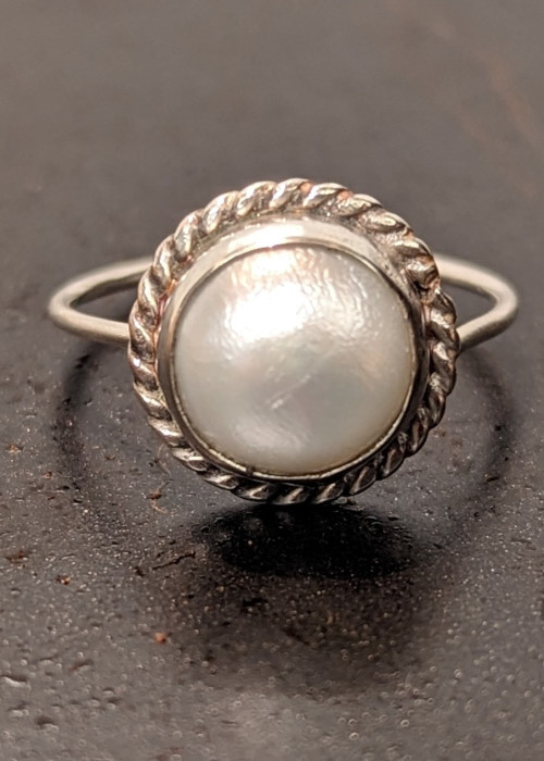 a ring with a pearl in it