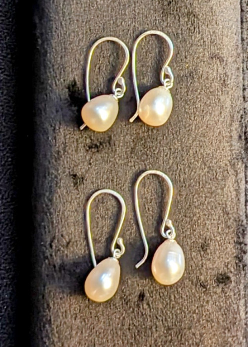 a group of earrings on a surface