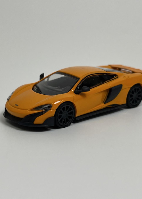 a yellow toy car on a white background