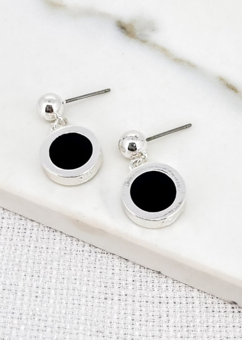 a pair of earrings on a white surface