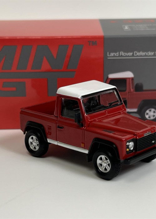 a red toy truck next to a box