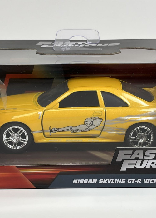 a yellow toy car in a box