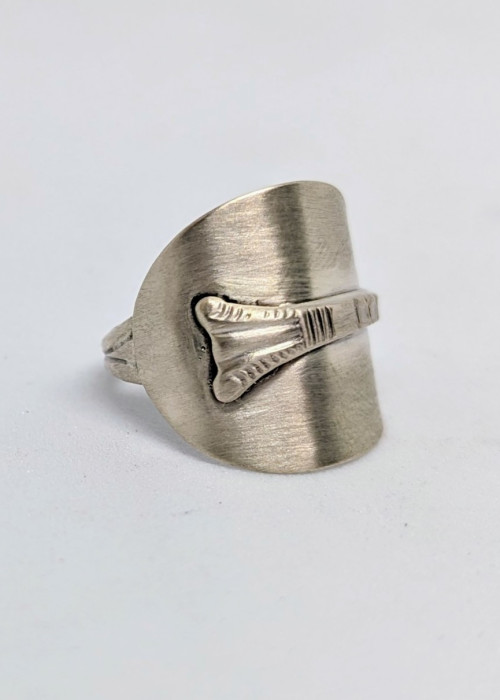 a silver ring with a design on it