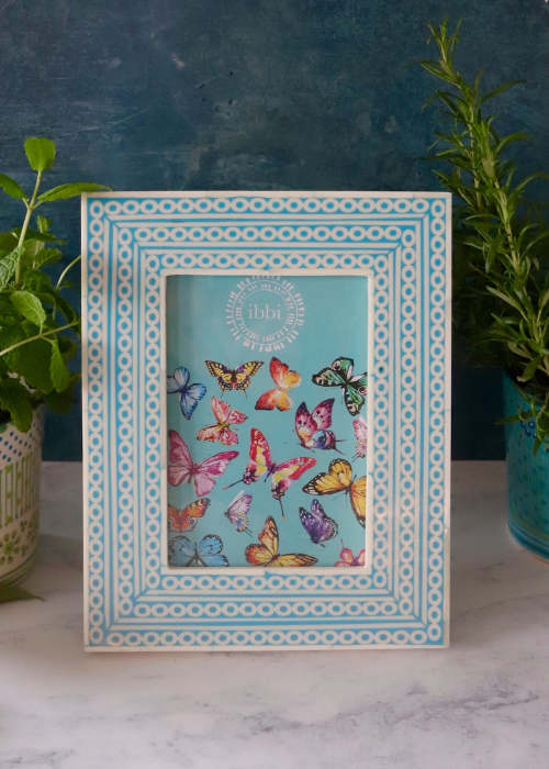 a picture frame with butterflies on it