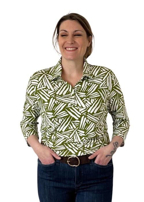 a woman smiling with her hands in her pockets