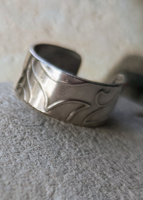 a silver ring on a surface